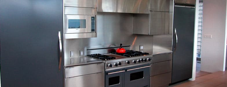 Kitchen with stainless steel cabinets, range and refrigerator