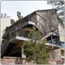 The same home after, with a rebuilt deck and railings