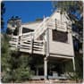 Mountain home before, with an old wooden deck