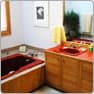 Master bathroom before, with a red tub surround